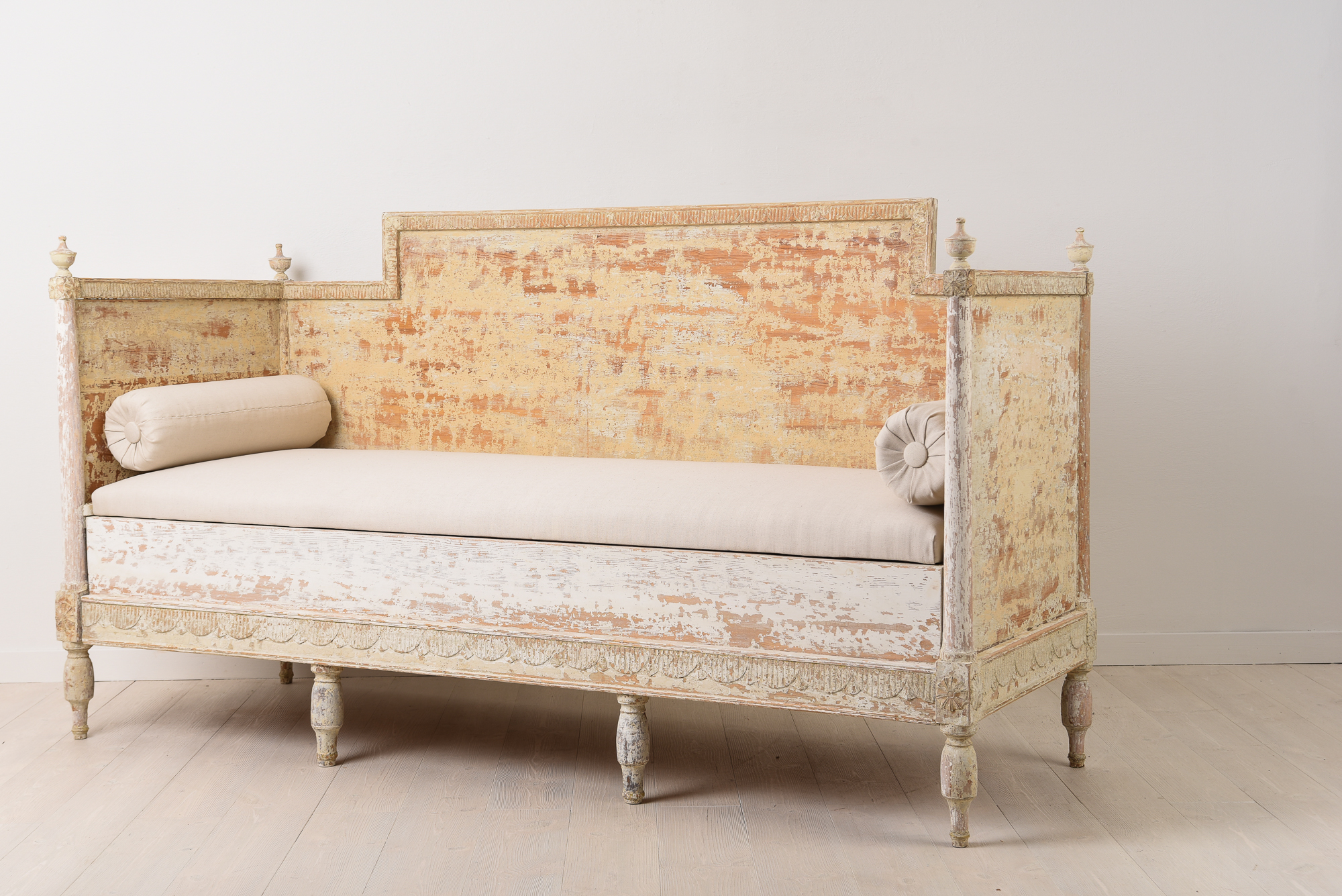 Gustavian sofa in painted pine. It has the original paint with natural distress and wear due to time. Hand carved wooden decor