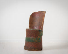 Swedish rustic Kubbstol from the turn of the century 1700 to 1800. The chair is folk art and primitive and made by hewing out a large log.