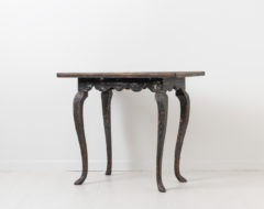 Black rococo table in painted pine from Sweden. The table is from the 1770s and painted with black historic paint from the 1800s. Naturally distressed paint