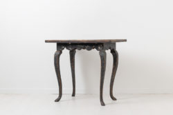 Black rococo table in painted pine from Sweden. The table is from the 1770s and painted with black historic paint from the 1800s. Naturally distressed paint