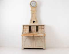 Antique clock secretary from northern Sweden. The clock is from around 1820 and dry scraped to the original light paint. Height to writers top is 70 cm