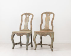 Charming rococo chairs from northern Sweden. The chairs are provincial and folk art with original distressed paint. Made around 1770 with hand carved wooden decor