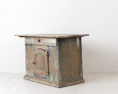 18th century chest table from Sweden. The chest is late 1700s and has traces of the original blue paint. The door has an older enforcement on the inside