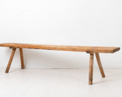Wide folk art bench in solid pine. The bench is from the early 1800s and has an authentic patina after 200 years of use. The seat is one single board