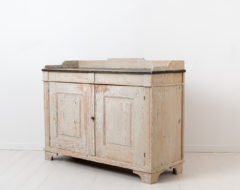 White gustavian sideboard from northern Sweden. The sideboard is from around 1790 and is in the gustavian style. The style got it's name from the Swedish king Gustav III