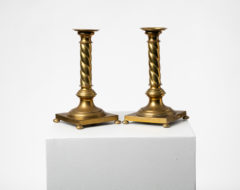  Swedish candle sticks in brass made during the later part of the 1800s. The pair are of the gustavian style with a square base, small round feet and a turned column