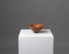 Stoneware bowl by Carl-Harry Stålhane with hare's fur glaze. The bowl is glazed with muted but fiery shades of yellow, orange and brown