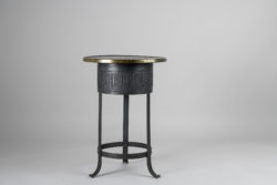 Swedish Art Deco table from the early 20th century, around 1920 to 1930. The table has a frame in metal with a patterned surface and a brass rim around the table top