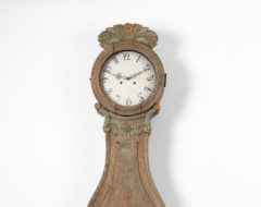 Rococo long case clock with a case in pine and dry scraped to the original first layer of paint. The clock is a so called Fryksdals clock