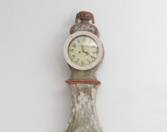 Long case clock with rococo shape from southern Sweden. The clock is hand-made from pine with hand-craved decor. Dry scraped to traces of the origina