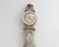 Long case clock with rococo shape from southern Sweden. The clock is hand-made from pine with hand-craved decor. Dry scraped to traces of the origina