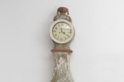 Long case clock with rococo shape from southern Sweden. The clock is hand-made from pine with hand-craved decor. Dry scraped to traces of the origina