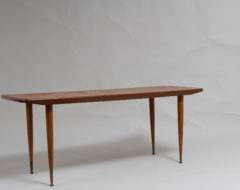 Scandinavian modern teak table from the 1960s. The coffee table has round slider legs with brass finishes. Good vintage condition consistent with age and use