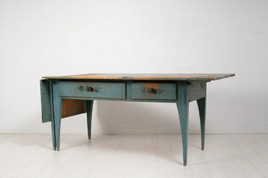 Unusual Swedish country table in gustavian style made in painted pine. The table has its original blue paint with initials and the year 1853 painted on the drawers.