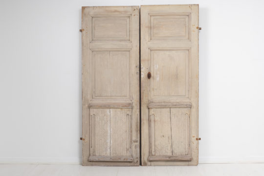 Pair of genuine gustavian doors from the late 1700s in pine. The doors are unusual and in authentic condition with old paint from the 1800s.
