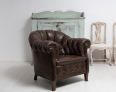 Brown leather Chesterfield armchair from Sweden made during the early 1900s. The chair is large and generous with the original leather