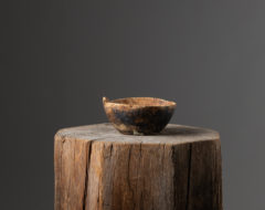 Rustic round wood bowl from Sweden made from a single piece of wood. The bowl has marks of use as well as a genuine patina of time