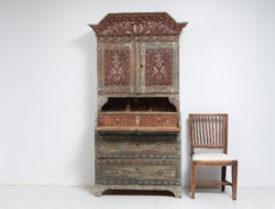 Folk art secretary cabinet in two parts. The secretary cabinet has two large drawers, a writing desk and two upper doors