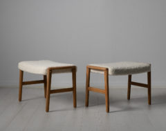 Scandinavian modern oak footstools from Sweden made around the 1960s. The stools are oak and newly upholstered. The cushions are upholstered with a special kind of white bouclé fabric