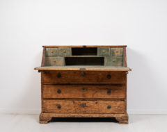 Swedish baroque secretary desk in pine from the late 1700s. The secretary is from northern Sweden and has distressed paint and a warm time-worn patina.