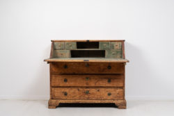 Swedish baroque secretary desk in pine from the late 1700s. The secretary is from northern Sweden and has distressed paint and a warm time-worn patina.
