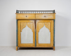 Country house empire sideboard from Sweden. The sideboard is from 1820 to 1840 and made in pine. It's an unusual model with a balustrade
