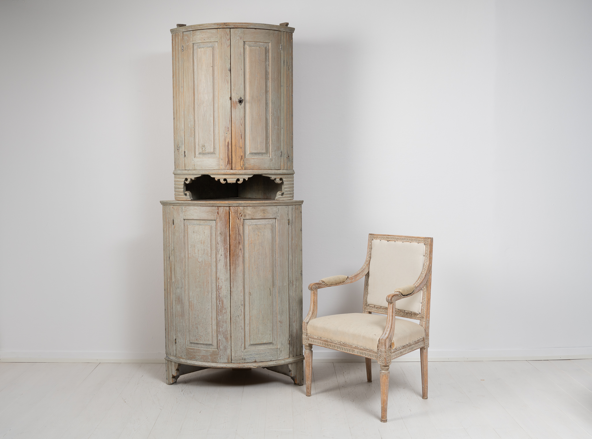 Tall gustavian corner cabinet in two parts. The cabinet has a rounded front with original paint from the time it was made