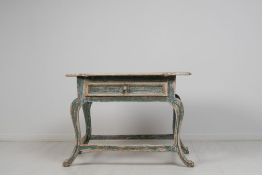 Unusual small rococo table from northern Sweden made around 1780 to 1790. The table is a country house furniture in painted pine with hand carved decor