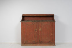 Folk art country sideboard from northern Sweden made during the early 1800s, around 1820 to 1840. The sideboard is painted pine with the original paint
