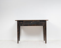 Black table in gustavian style from the early 19th century, 1820 to 1840. The table is a classic country house furniture from Sweden and made in pine