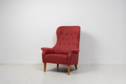 Red armchair by Carl Malmsten from Sweden made during the mid 20th century, around 1960 to 1970. The armchair has the sleek lines
