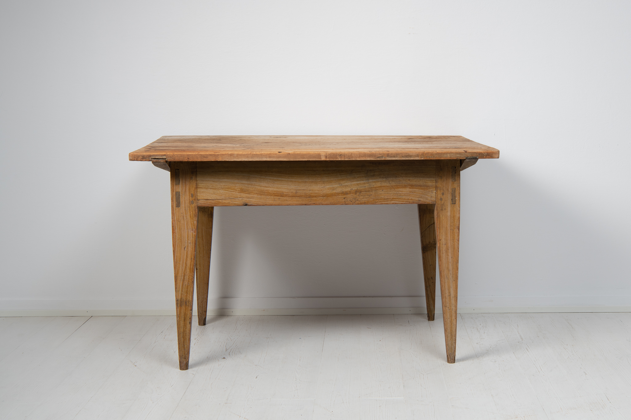 Swedish work or dining table in folk art from the early 19th century, around 1820. The table is genuine and honest with a solid frame and simple design