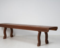 Swedish country house bench made in solid pine during the mid 19th century, around 1850. The legs are curved with a simple hand-carved detail above the foot