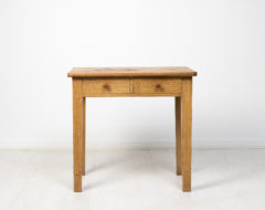Primitive folk art table from Sweden made during the early 1800s. The table has a simple construction with a solid frame, straight legs