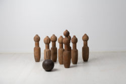 Swedish antique bowling set from the mid 19th century, around 1850. The set, a skittles or ninepins game as it's also known, has nine pins in pine and one ball.