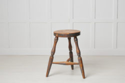 Antique Swedish country stool in folk art made with three legs. This stool is from northern Sweden and made around the 1860s