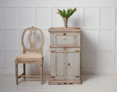 Antique Swedish tall sideboard in an unusually tall and narrow model with an uncommon function. Underneath the table top there is a large sugar hack attached