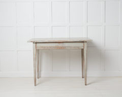 Antique country house table in gustavian style made with a wide drawer across the front. The table has a carved wood decor made by hand