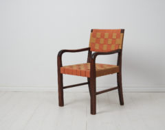 Swedish modern vintage armchair made during the early 20th century, around 1920 to 1930. The chair has a frame in birch which has been stained dark brown