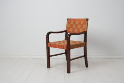 Swedish modern vintage armchair made during the early 20th century, around 1920 to 1930. The chair has a frame in birch which has been stained dark brown