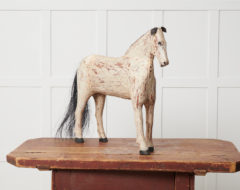 Swedish antique wooden horse in folk art from northern Sweden. The horse was carved by hand from solid Swedish pine around 186o to 1880