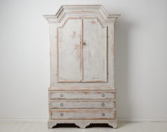 Antique folk art cabinet from northern Sweden made during the early 1800s, around 1810 to 1820. The cabinet is made by hand in two parts