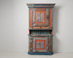 Stately folk art cabinet made by hand from Hälsingland in northern Sweden. The antique cabinet is made in two parts from Swedish pine