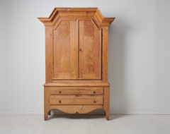 Antique folk art cabinet from Sweden made during the first years of the 19th century, around 1810. The cabinet is made by hand in solid pine