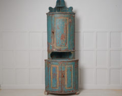Antique Swedish corner cabinet. The cabinet is a genuine Swedish country house furniture from the early 1800s. Old historic and rustic paint