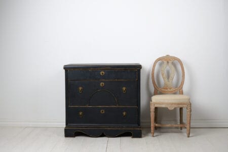 Antique Swedish chest of drawers in empire style from around 1840. The chest is made by hand in solid pine with three large, functional drawers.