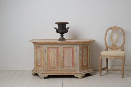 Antique Swedish sideboard from Norrbotten in northern Sweden made around 1820. The sideboard is low and wide and has an unusual shape with slanted corners,
