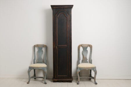Antique Swedish narrow cabinet with a single door. The cabinet has an unusual shape, tall and narrow. Made by hand in northern Sweden around the 1840s