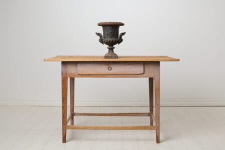 Antique Swedish country table in untouched condition. The table has a drawer and straight legs as well as original paint that shows the age
