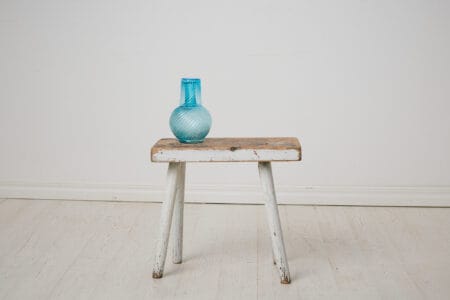 Antique folk art stool from northern Sweden. This charming stool is made by hand around 1860 in solid pine. Original paint with distress and patina.